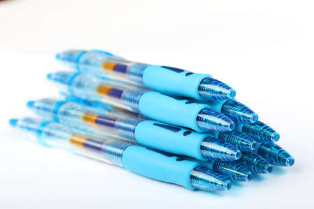 Group of ten blue transparent plastic gel pens on a white backgroundの写真素材