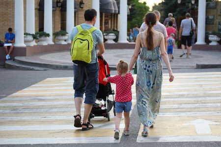 Pyatigorsk, Russia - July 25, 2018: Family with a baby stroller crosses the street on a pedestrian crossingのeditorial素材