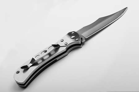 Steel folding knife with an open blade on a white background. Steel armsの写真素材