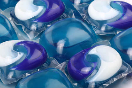 Laundry detergent pods (or packs) in a row. Concept of chemical products for home works or abstract backgroundの写真素材