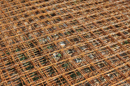 Stacked rusty steel wire mesh for slab concrete work at the construction site. Backgroundの写真素材