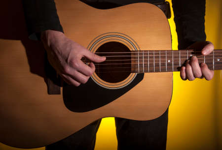 Playing music, learning to play guitar Strings to sound For entertainment purposes.Close up.