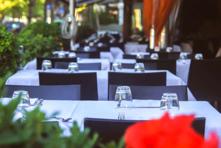 beautifully served table, on the street of the restaurant, white tablecloths on the tables, empty chairs. Italian provinceの写真素材