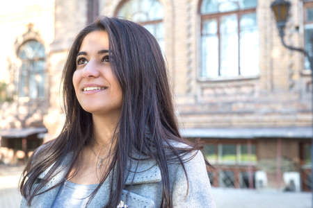 portrait of a beautiful young indian girl, smiling. Against the background of an old building. The...