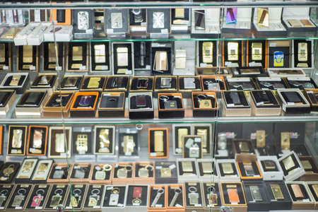 Zaporozhye, Ukraine. October 2019. A variety of lighters, zippo, piezo lighters, on the counter in the store. The general plan lighters with prints, gasoline, silicon, electro-lighter, gasのeditorial素材