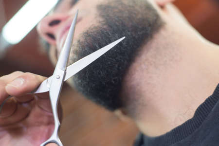 Beard man, bearded male. Portrait beard man. Barber scissors and straight razor, barber shop, suit. Vintage barbershop, shaving. Mustache men. Beard macho man. Brutal guy, scissors, straight razor.の写真素材