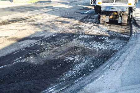 road repair work. A team of working engineers, laying asphalt. Cars asphalt stealers, ride the roadの写真素材