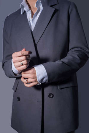 catalog photo of a fashionable red-haired girl in a gray business jacket made of high-quality...