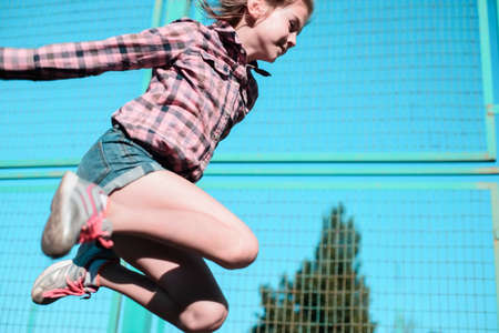 Portrait of a little girl jumping ropeの写真素材