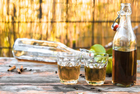 apple juice, in glasses, poured in bottles, on an old wooden table. In a rustic style. Vintage. In a warm, unusual finish. Summer concept. Autumn moodの写真素材