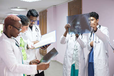 medical students, interns. Young doctors, mixed race, in the corridor of the hospital, consultation....