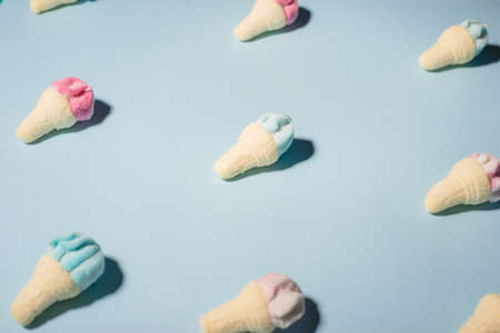 Trendy sunlight Summer pattern made with pink strawberry ice cream on bright light blue background....