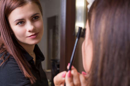 beauty saloon. Professional makeup artist Portrait of a young beautiful makeup artist girl. Makeup...