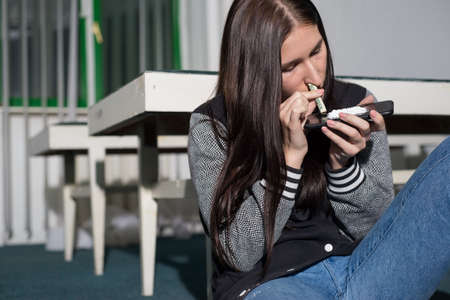 Portrait of a young cocaine girl using coca powder and a straw from a dollar. The problem of drug...