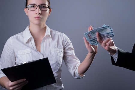 Portrait of a business girl in glasses with serious emotions on her face, with a hand prohibits...