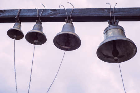 Orthodox bells closeup against the sky with clouds. New Jerusalem in town Istra, surroundings church bell, in the yard, against the skyの写真素材