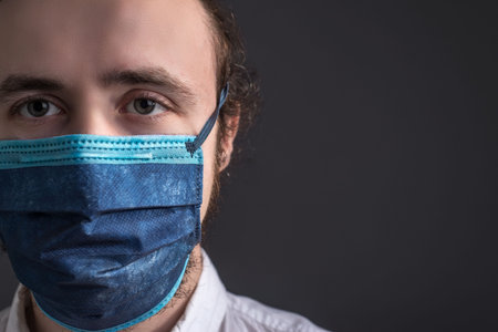 Nurse wearing respirator mask holding a positive blood test result for the new rapidly spreading Coronavirusの写真素材