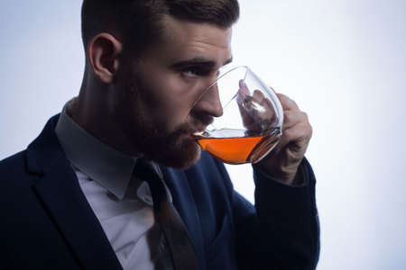 close-up, on a clearance on a white background, silhouette of a bearded handsome guy drinking tea...