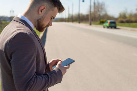Young woman enjoying the fresh air. Portrait of a young guy of twenty-five years old, in a business...