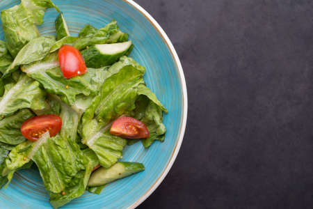 salad with vegetables and greens on wooden table Close-up top view, fresh vegetable salad with fresh ingredients. Vegetarian lunch. Breakfast with salad. Country style. Vegetable stew. Lenten snacks. An empty breakfast. Light spring vegetable salad.の写真素材