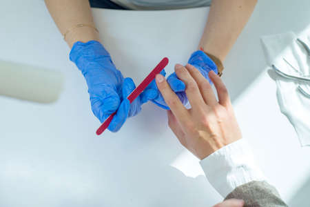 Close-up of male manicure for a man of thirty years. The beauty of male nails, care for male nails. Health and beauty of nails, sawing nails in an elephant manicure close-up.の写真素材