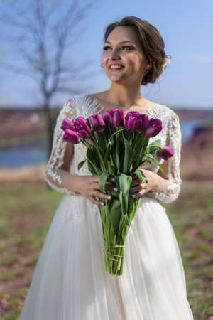 A smiling weightless woman stands with her back showing patterns of a wedding dress.の写真素材
