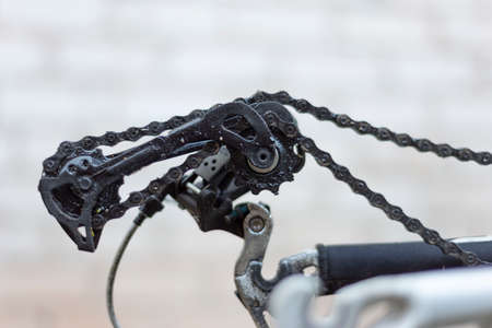 the rear derailleur of the bike is broken, no wheel. close-up, on a white background Closeup of rear...