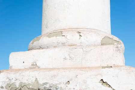 white vintage antique column of technical, cracked, cracked plaster. repair of the building column....