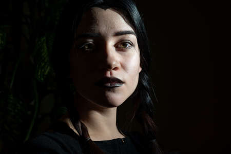 goth halloween girl, in black. close-up thematic portrait dramatic Gothic girl on cemetery.の写真素材