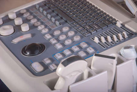 An ultrasound doctor examines the neck and abdomen in a child using an ultrasound electrode