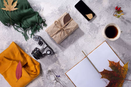 autumn flatlay of clothes in warm yellow and gray-white shades Women's fashion clothes and accessories on white background. Flat lay female golden styled look. Top view.の写真素材
