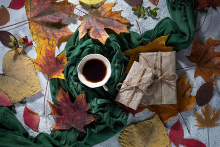 top view autumn still life gift. festive texture of autumn items Gift box in fall foliage. Autumn...