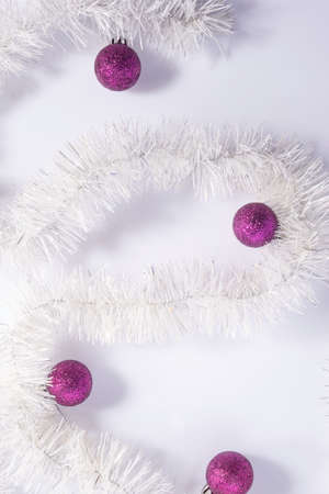 christmas flatlay with purple decorations on white background Winter holiday design. Elegant...