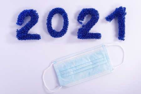 coronavirus christmas concept, medical protective mask, next to the numbers from the new year...