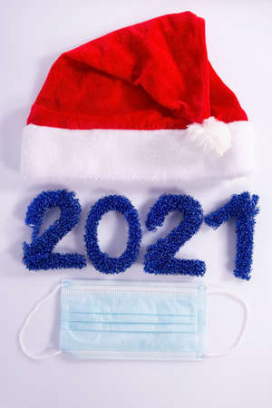 numbers laid out 2021, coronavirus christmas concept. Santa coronavirus Santa Claus hat and beard...