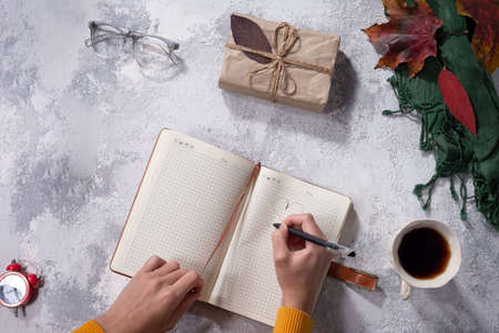 autumn flatlay of clothes in warm yellow and gray-white shades Women's fashion clothes and accessories on white background. Flat lay female golden styled look. Top view.の写真素材