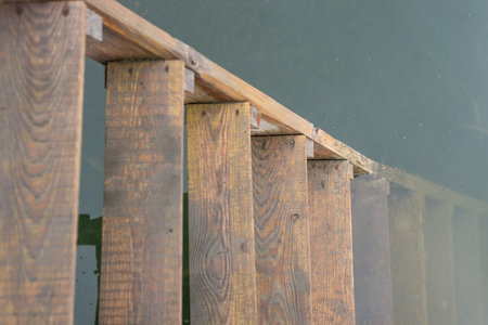 old wooden ladder in the water close up