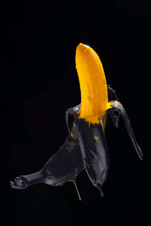 banana paint. Yellow-black painted banana on a black background levitationの写真素材