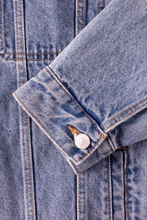 A close-up photo of one element of a common denim jacket