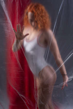 portrait of a girl in white on a red backgroundの写真素材