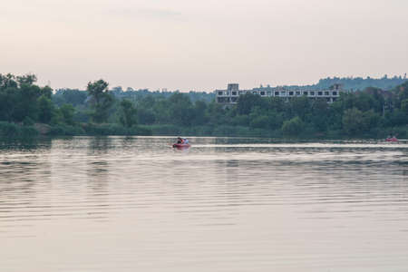 Krivoy Rog. Ukraine. July 2021. Athletes row boats on the city river.のeditorial素材