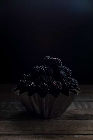 black berry on a black background in a rustic style.の写真素材