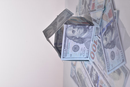house made of dollar bills on white background concept.の写真素材