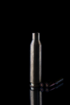 high caliber cartridge case on black background.の写真素材