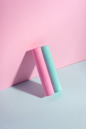 blue pink cylindrical chalk on pink blue background minimal.の写真素材