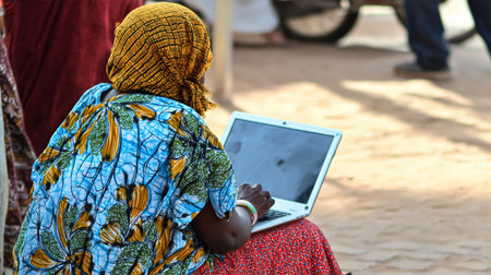 Indian Asian young working professional female working on laptop at home wears smart formals.の素材