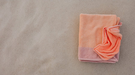 Aerial view of living coral towel on sand and beach. Free space for your decoration. Summer time.の素材