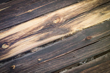 very old logs of the house wall, horizontal, tow, cracks, defects