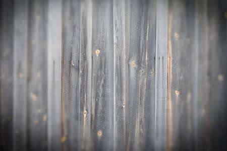 very old logs of the house wall, horizontal, tow, cracks, defects, vignettedの写真素材