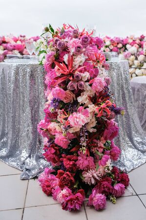 Pink peonies and other flowers decoration on a festive tableの写真素材